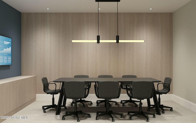 dining area featuring baseboards and light colored carpet