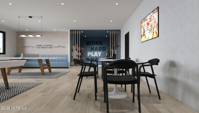 dining space with wood finished floors and recessed lighting