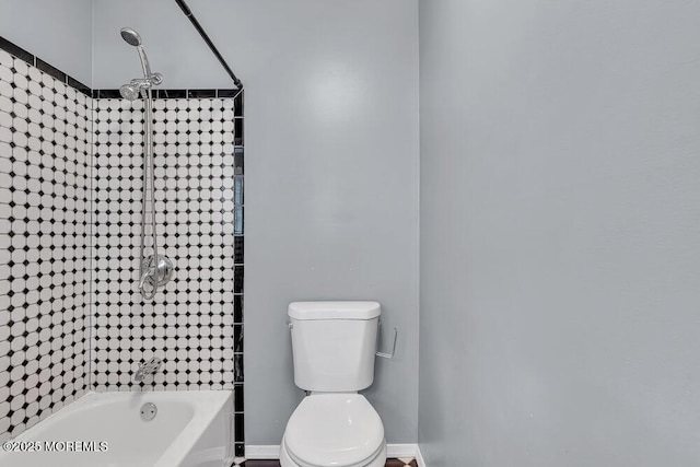 bathroom with shower / washtub combination and toilet