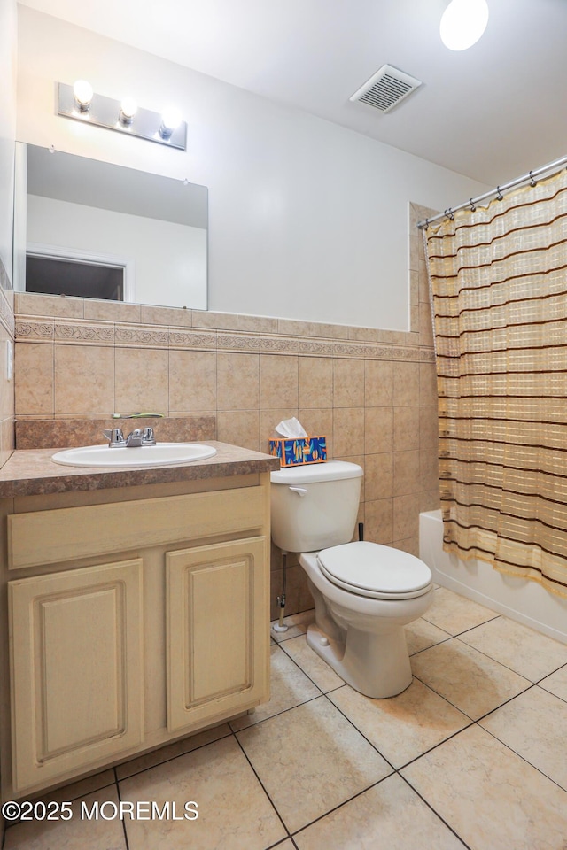 full bathroom featuring toilet, tile walls, vanity, shower / bath combo, and tile patterned flooring