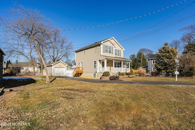 exterior space with a yard, a garage, an outdoor structure, and a porch