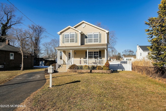 view of front of house with a porch and a front yard