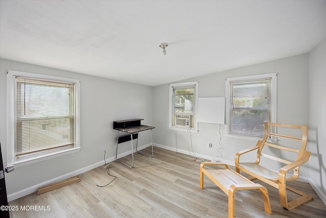 sitting room with cooling unit and light hardwood / wood-style flooring