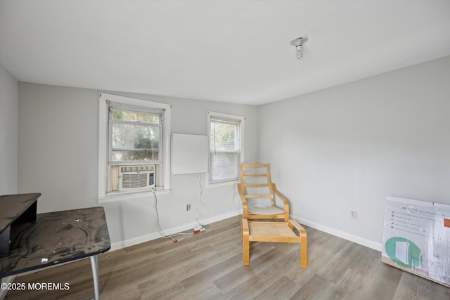 sitting room featuring cooling unit and light wood-type flooring