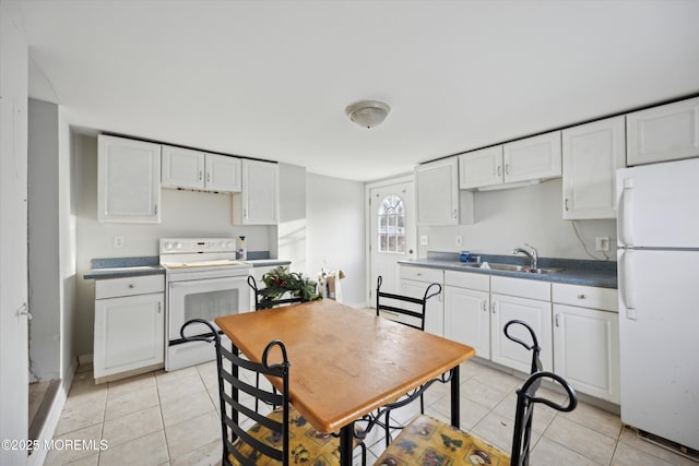 kitchen with white cabinetry, sink, light tile patterned floors, and white appliances