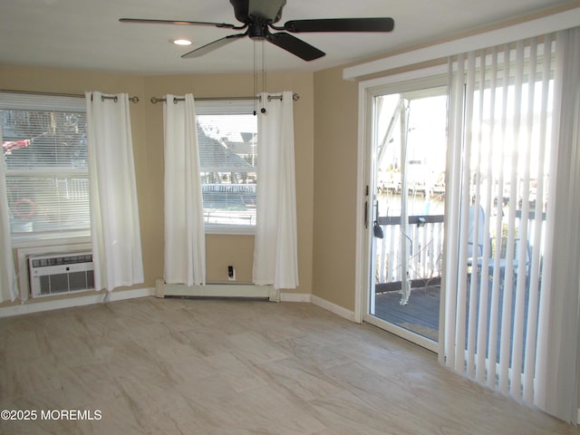 unfurnished room with a baseboard radiator, ceiling fan, and a wall unit AC