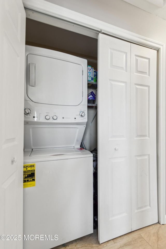 laundry area with stacked washing maching and dryer