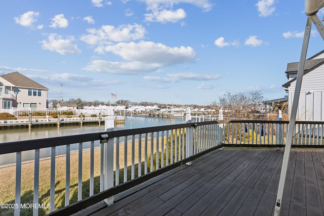 wooden terrace featuring a water view