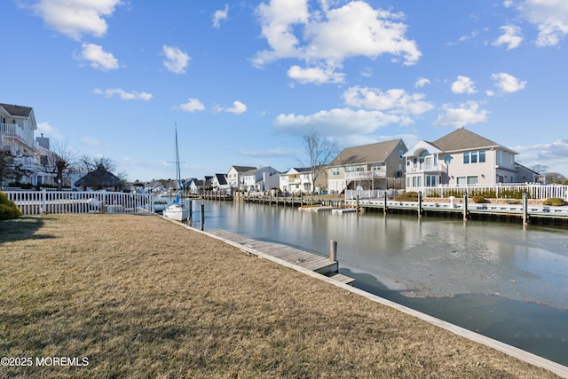 view of dock featuring a water view and a yard