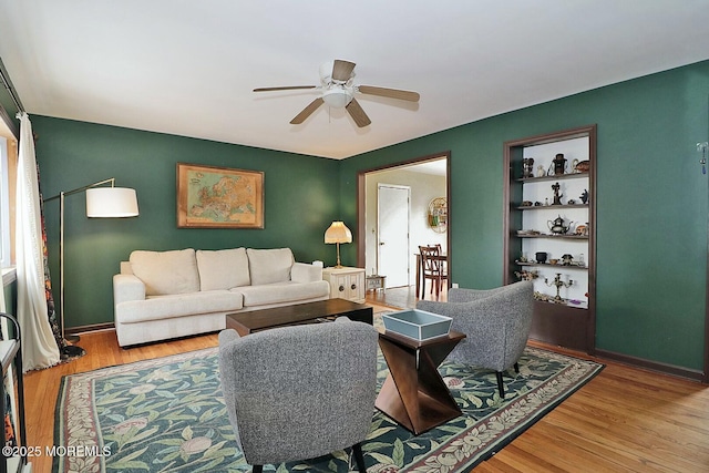 living room featuring ceiling fan and wood-type flooring