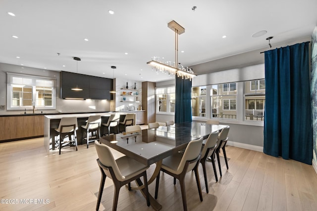 dining space featuring sink and light hardwood / wood-style flooring