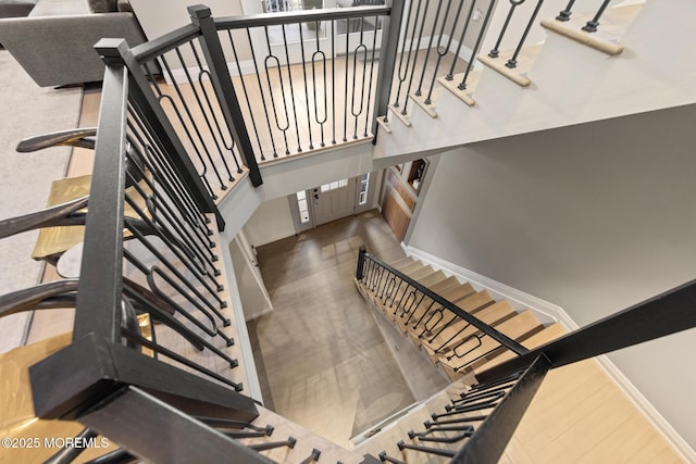 staircase with hardwood / wood-style flooring