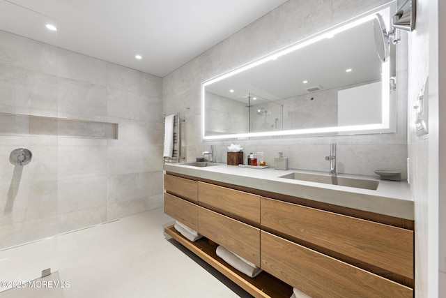 bathroom featuring vanity and a shower