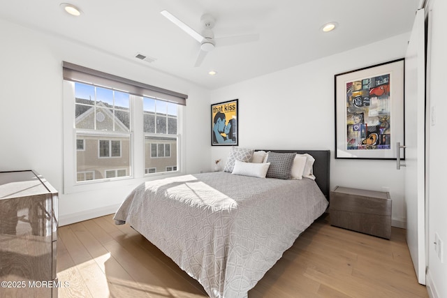 bedroom with ceiling fan and light hardwood / wood-style floors