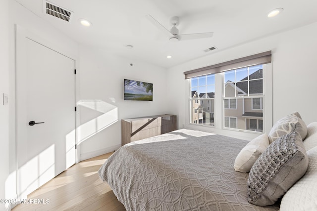 bedroom with ceiling fan and light wood-type flooring