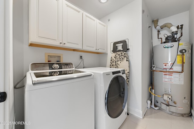 laundry area featuring cabinets, independent washer and dryer, light tile patterned floors, and gas water heater