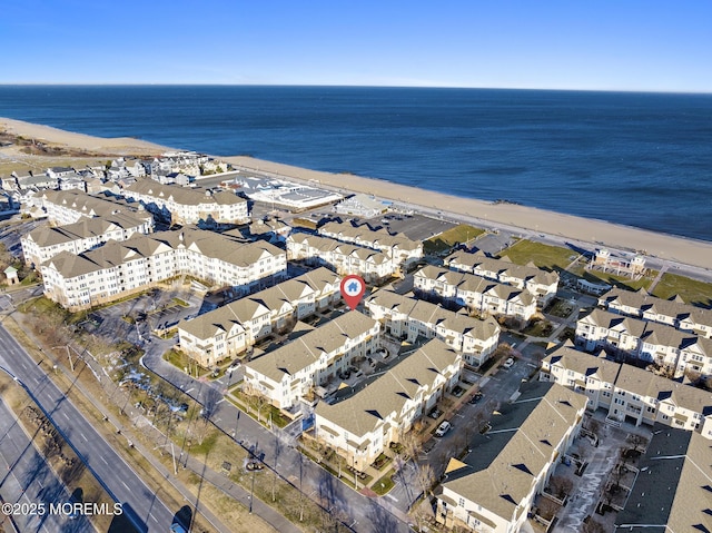 birds eye view of property featuring a water view and a beach view