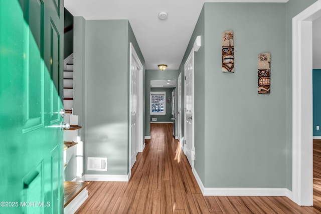 hall with hardwood / wood-style flooring