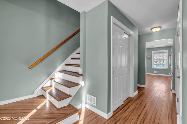 stairs with hardwood / wood-style floors