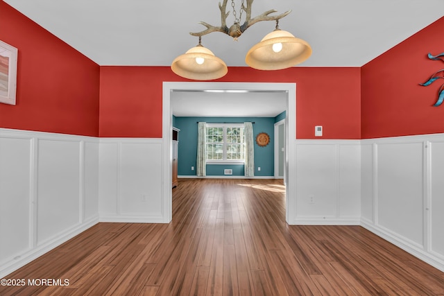 unfurnished dining area featuring hardwood / wood-style floors