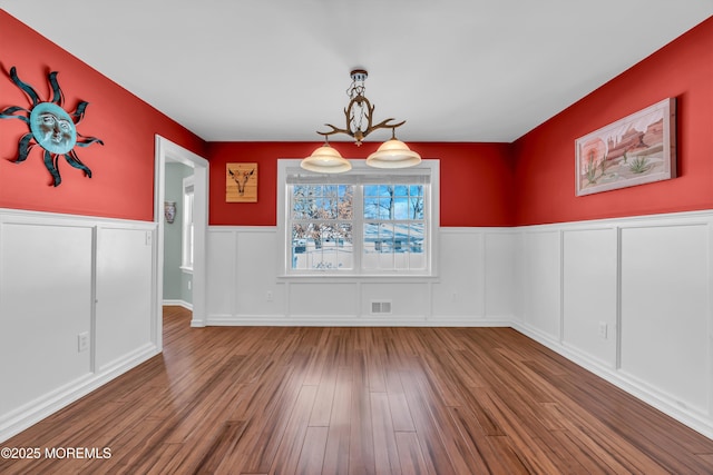 unfurnished dining area with hardwood / wood-style flooring