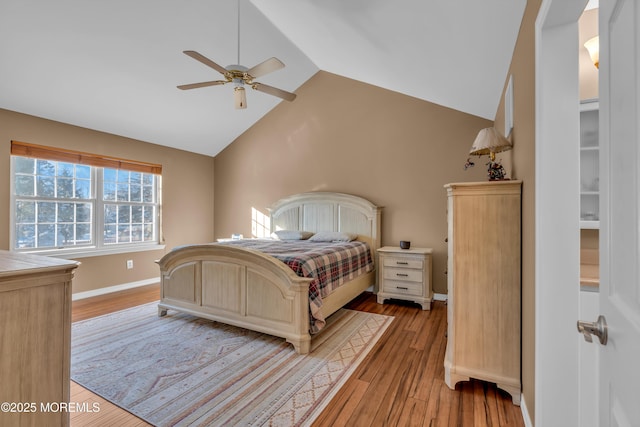 bedroom featuring ceiling fan, lofted ceiling, and light wood-type flooring