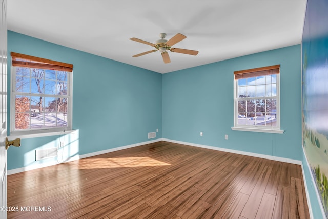 empty room with hardwood / wood-style flooring and ceiling fan