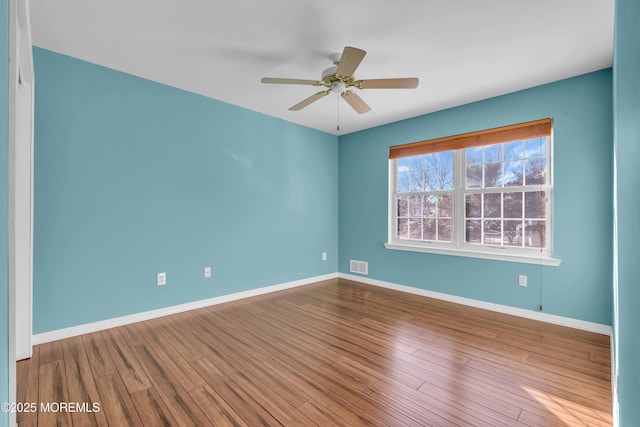 spare room featuring ceiling fan and light hardwood / wood-style flooring