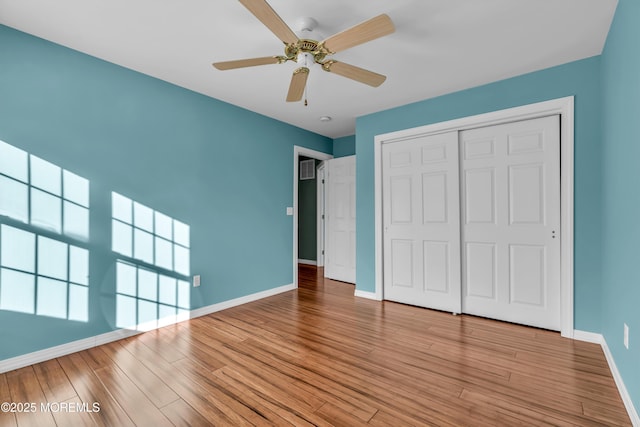 unfurnished bedroom featuring light hardwood / wood-style floors, a closet, and ceiling fan