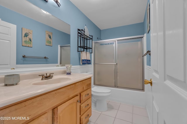 full bathroom featuring enclosed tub / shower combo, tile patterned floors, toilet, and vanity