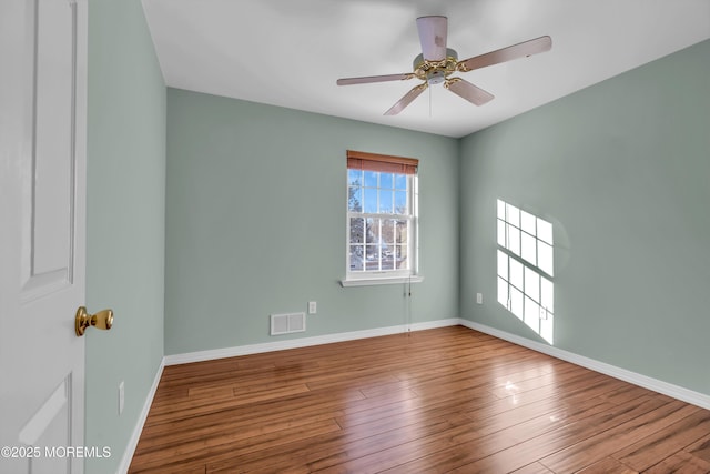 spare room with hardwood / wood-style floors and ceiling fan