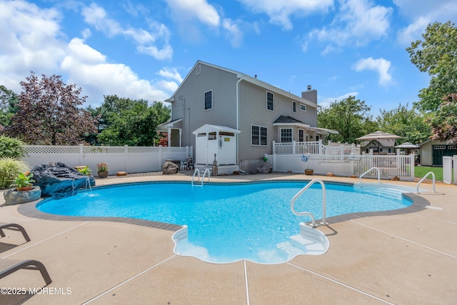 view of swimming pool featuring pool water feature and a patio