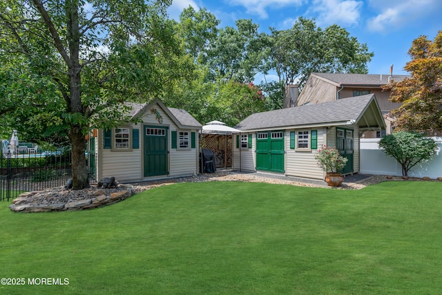 rear view of house with a storage unit and a lawn