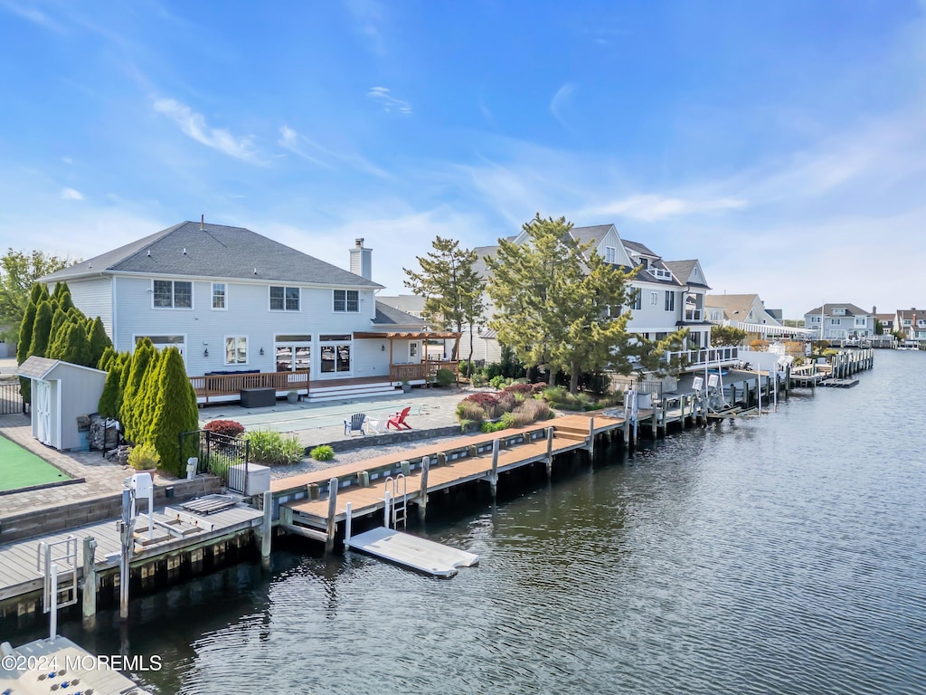 dock area with a deck with water view and a patio area