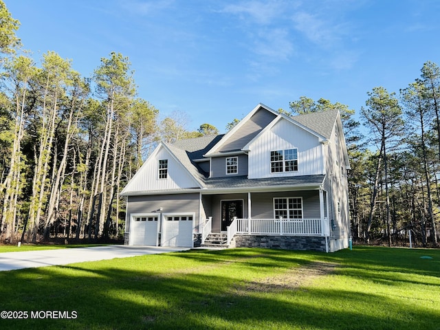 view of front of house with a garage, a front lawn, and a porch