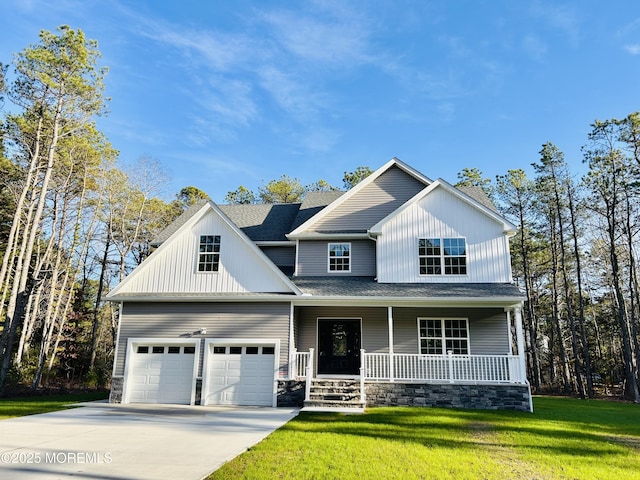 view of front facade with a garage, covered porch, and a front yard