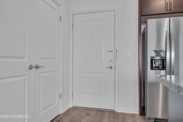 doorway to outside with light wood-type flooring