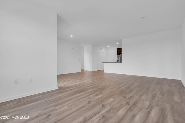 unfurnished living room with light hardwood / wood-style floors