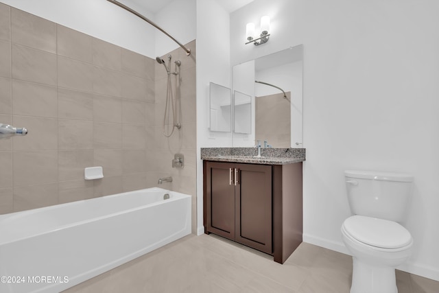 full bathroom with vanity, tile patterned flooring, toilet, and tiled shower / bath