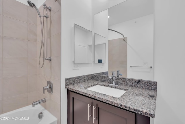 bathroom with vanity and tiled shower / bath