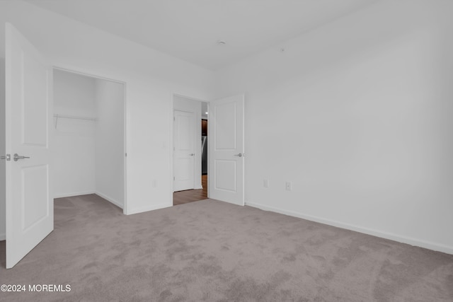 unfurnished bedroom featuring carpet and a closet