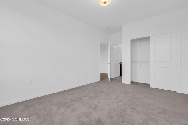 unfurnished bedroom with a closet and carpet