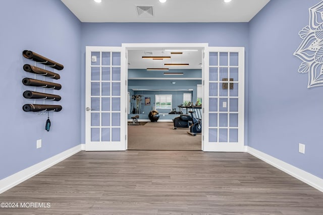 interior space with wood-type flooring and french doors