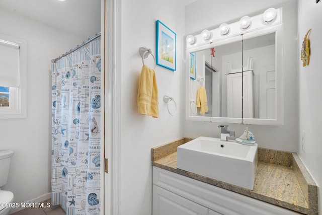 bathroom with vanity, a shower with shower curtain, and toilet