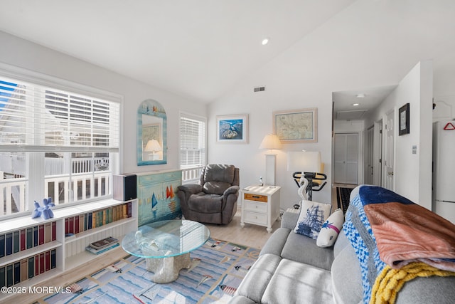 living room with lofted ceiling and light hardwood / wood-style floors