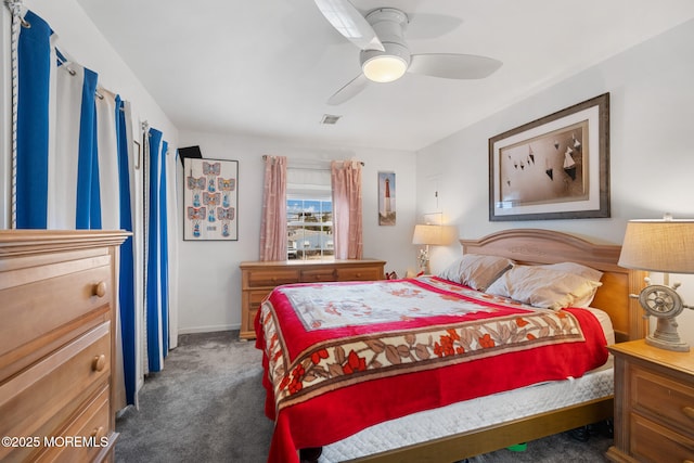 bedroom with ceiling fan and dark colored carpet