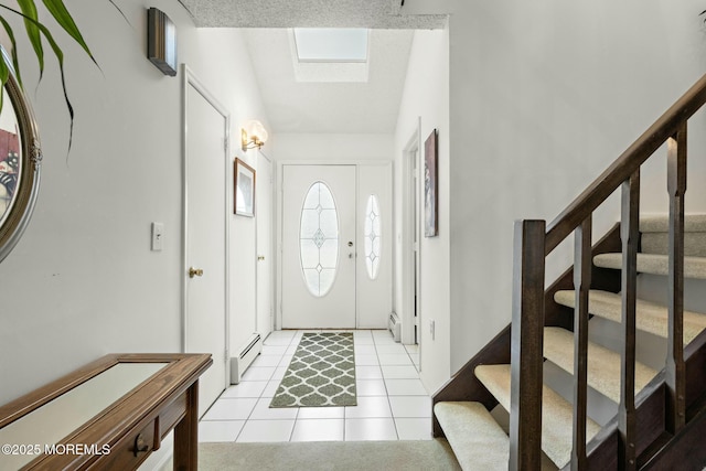 tiled entrance foyer with lofted ceiling with skylight and a baseboard heating unit