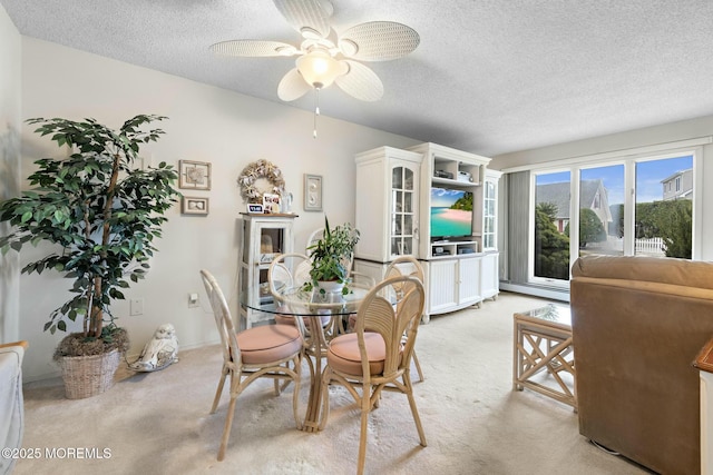 dining area with light carpet, a baseboard heating unit, a textured ceiling, and ceiling fan