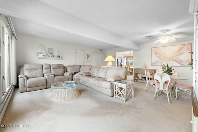 living room featuring ceiling fan, a baseboard radiator, a textured ceiling, and carpet flooring