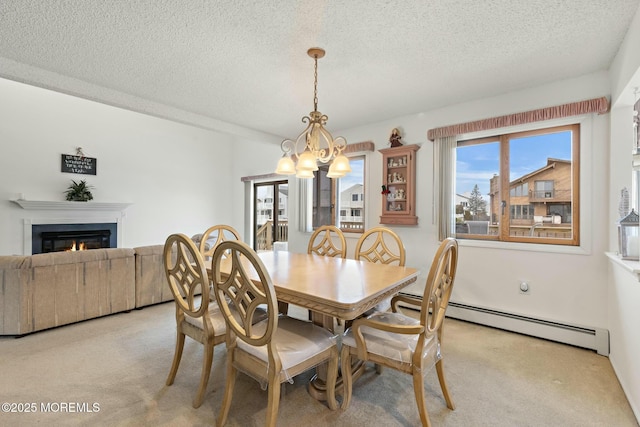 dining room with light colored carpet, a chandelier, a textured ceiling, and baseboard heating